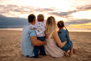 back-view-of-family-watching-sunset-on-beach-2022-11-10-09-14-09-utc Large
